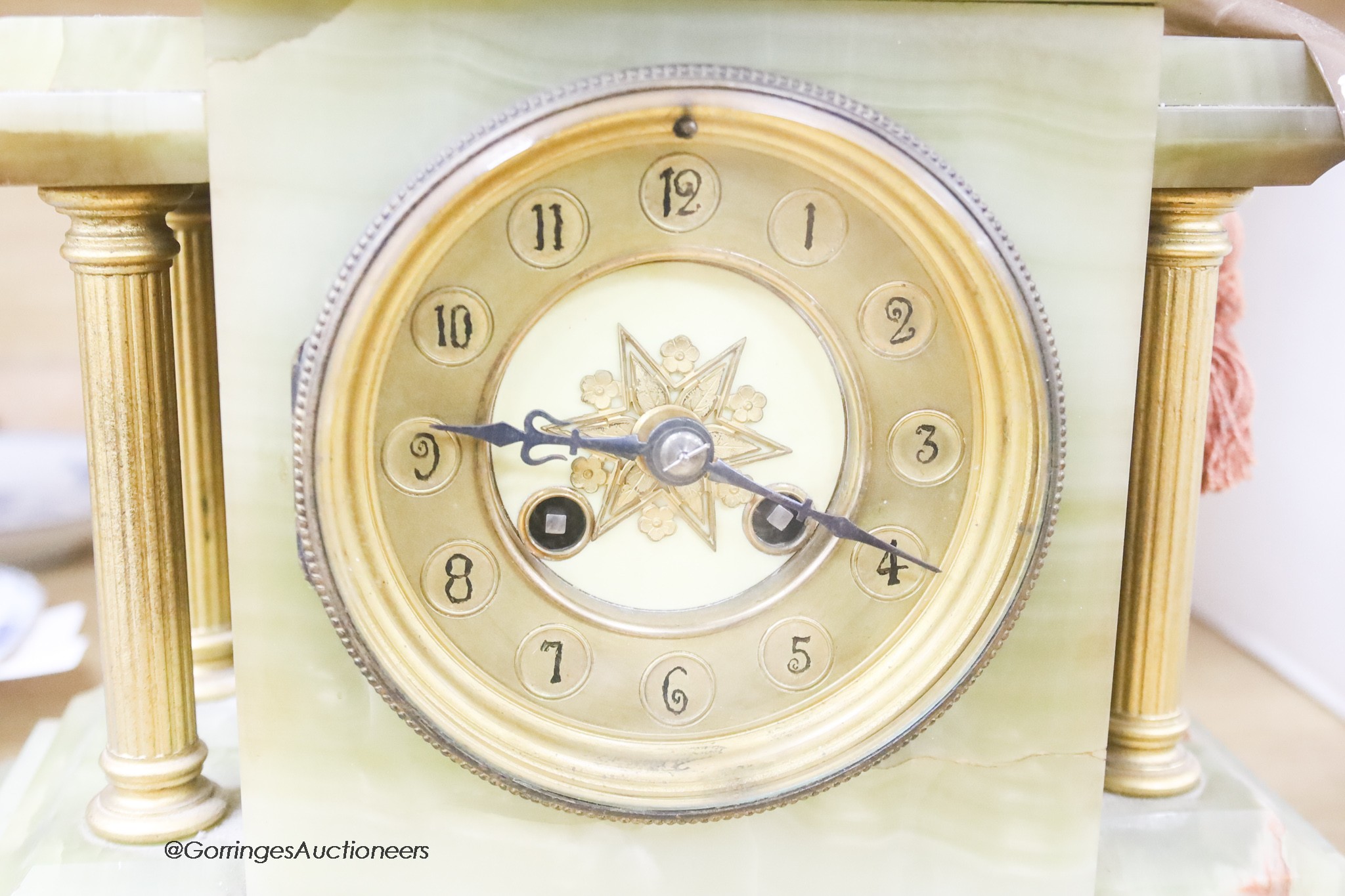 A French onyx and gilt metal mantel clock, with pendulum and key, height 34cm